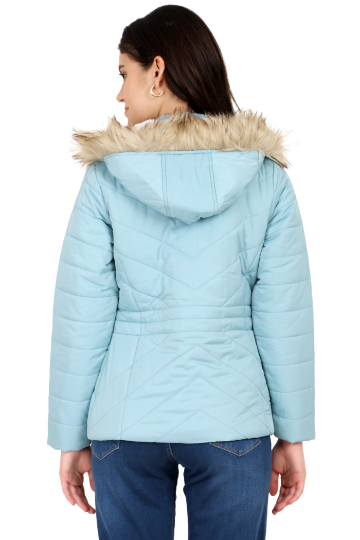 A back pose of a standing woman, wearing Coatsnmore’s coatsnmore’s casual jacket in Sea Green colour with a textured pattern, a removable hood and blue jeans.